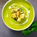 This silky roasted zucchini soup is packed with flavour from roasted garlic, peas, basil and vegan parmesan, and topped with crispy ciabatta croutons and pine nuts. #vegan #plantbased #veganfood #vegetarian #soup