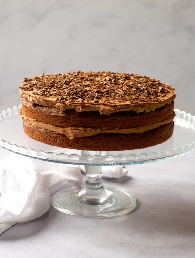 whole vegan chocolate cake on cake stand